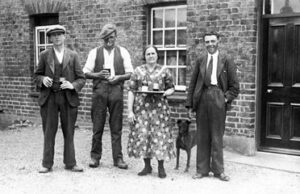 Old black & white photo of Sid Briston, Jack Ketteringham, Lucy Kent & Jack Lewis c1930 outside the Victory pub